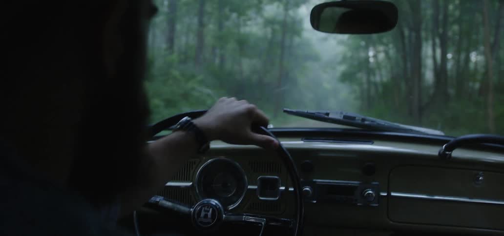 Young Driving Vintage Volkswagen Bug