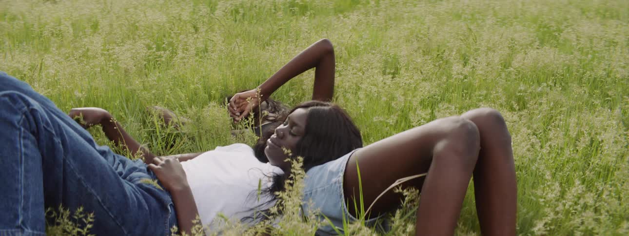 Two girls relax in the long grass