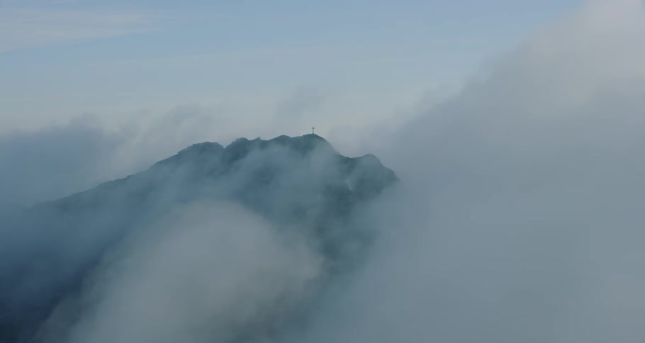 Mountain peaks are covered in clouds