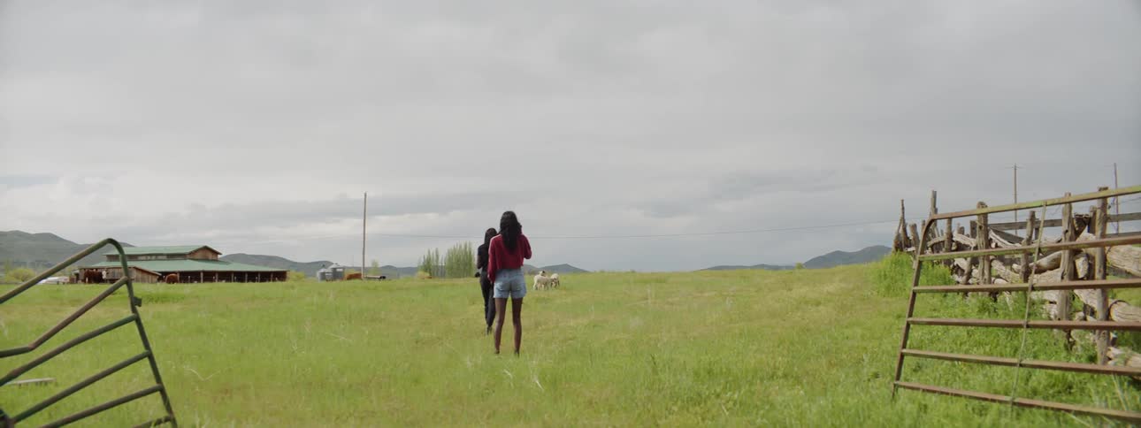 Two girls are in a field at daytime