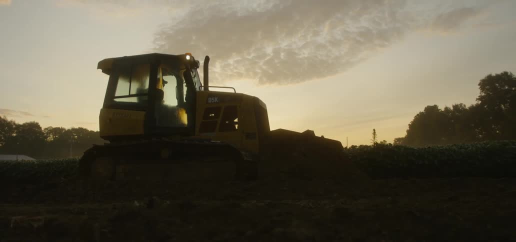 A large tractor moves over the ground