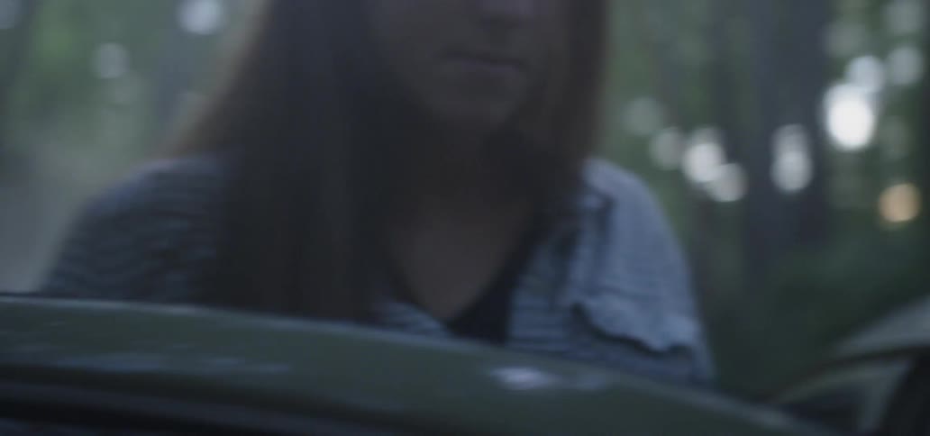 Young woman gets into passenger side of old car