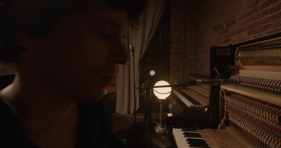 A man playing a piano and a woman playing a keyboard