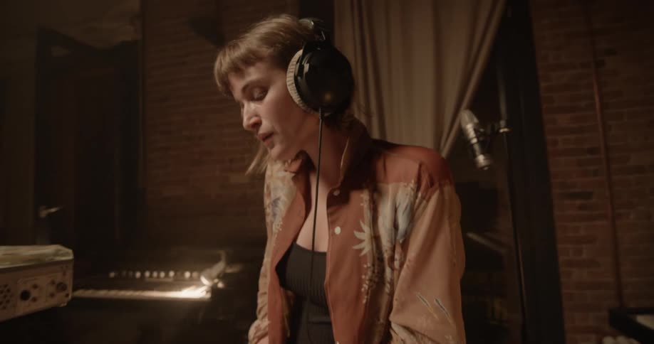 A woman is wearing headphones indoors