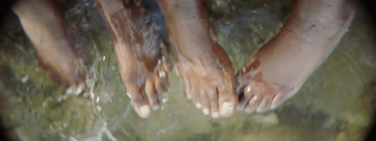 People are soaking their feet in water and splashing