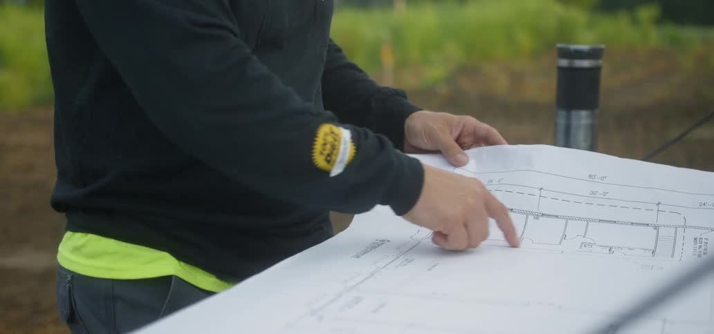 A construction worker studying a blueprint