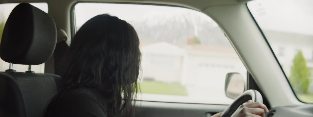 A woman drives a car