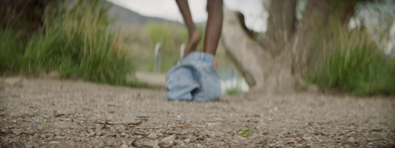 A person is walking by a beach outdoors