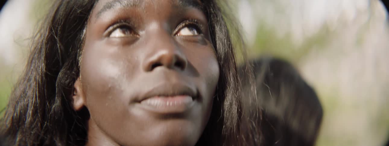 A woman is outside looking up