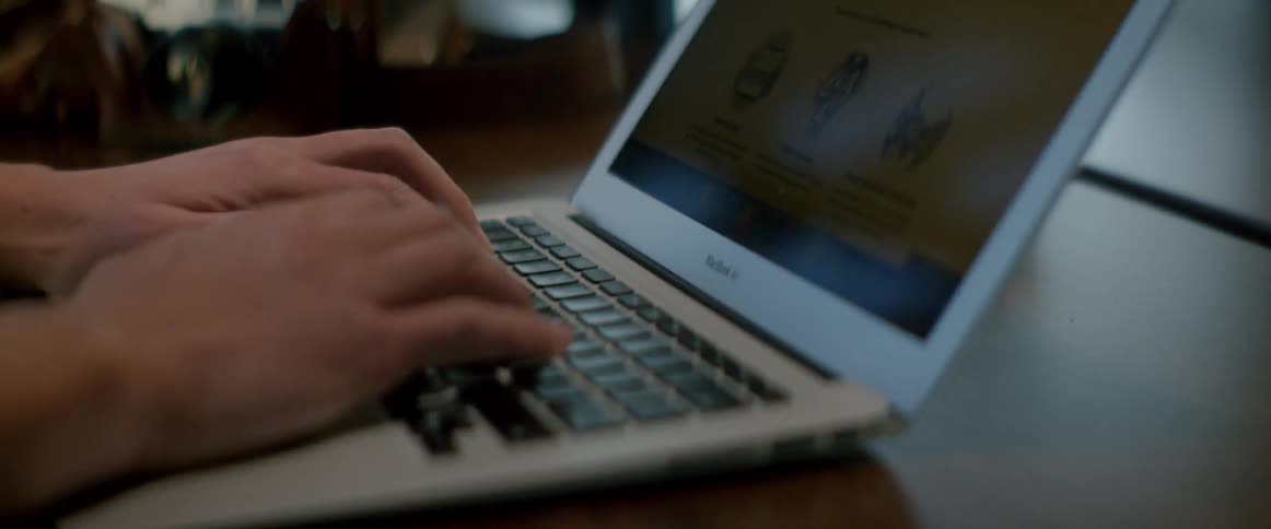 A man typing on a laptop