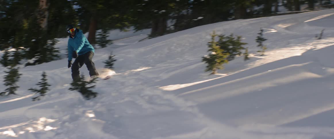 A person snowboards down a hill