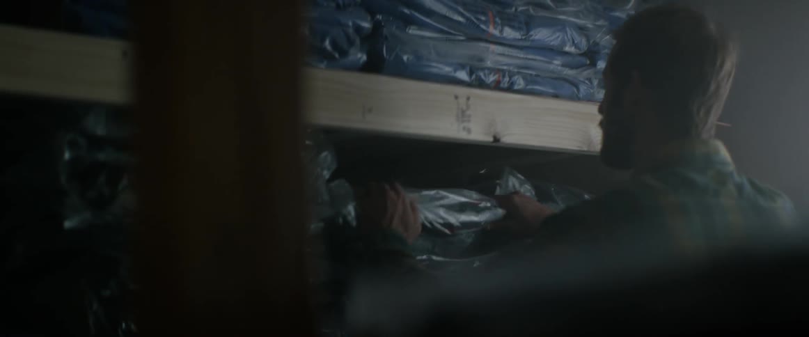 A man grabbing a package from a shelf