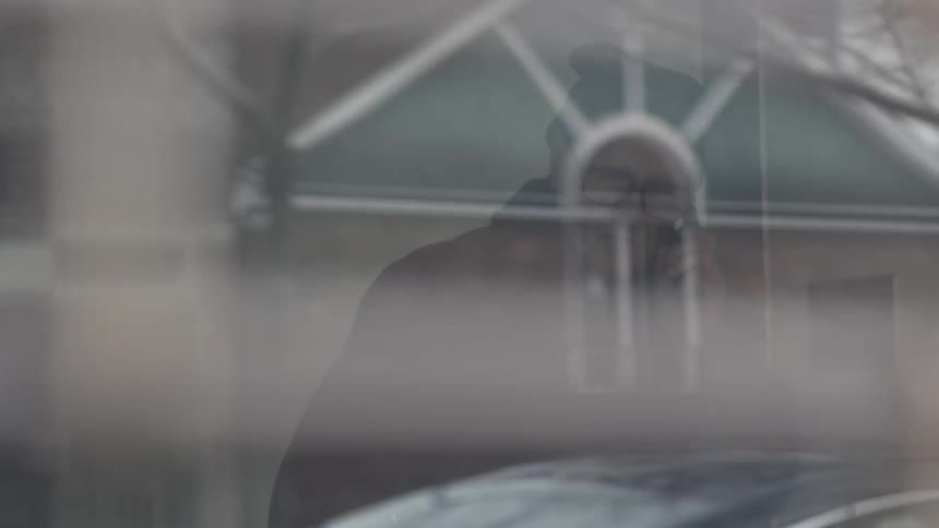 A man is looking out a window