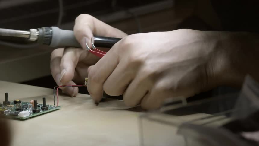 A man is repairing a circuit