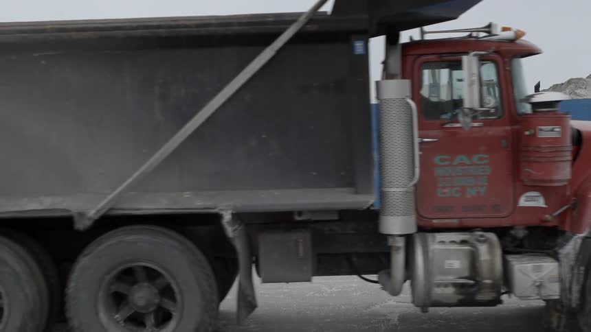 A dump truck driving by