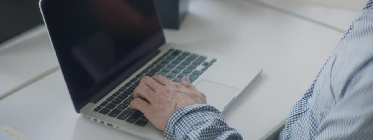 A person is typing on a laptop