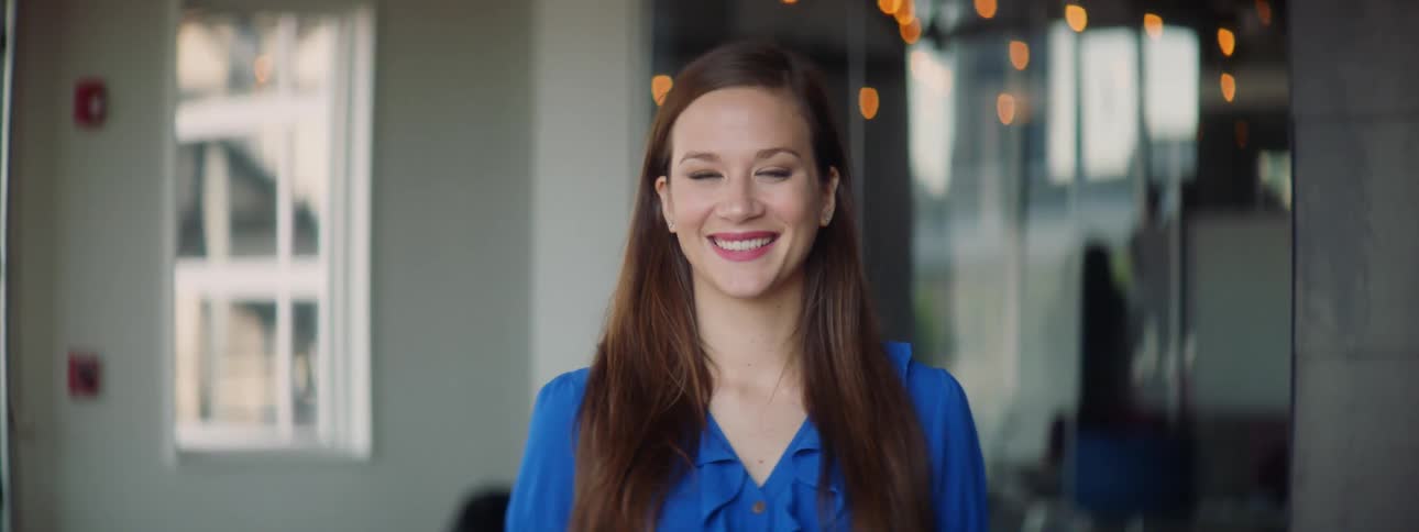 A woman standing and smiling