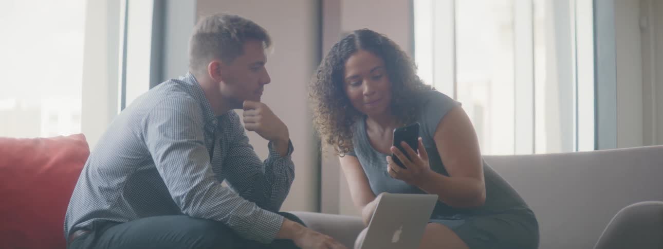 Woman and man talk while sitting near each other