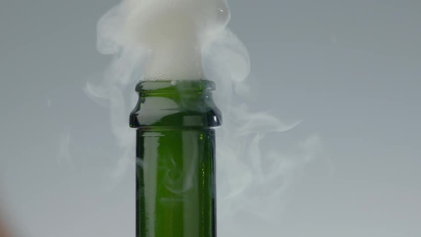 A cork screw blowing off a champagne bottle