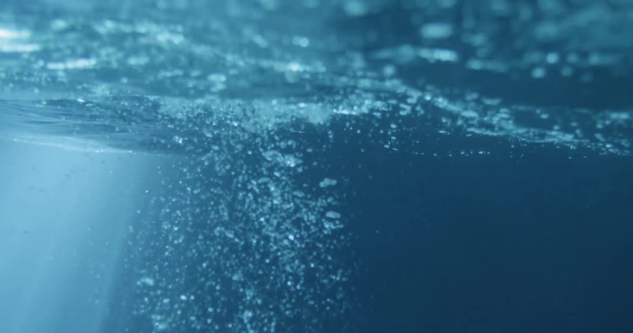 Water flows and bubbles illuminated by light