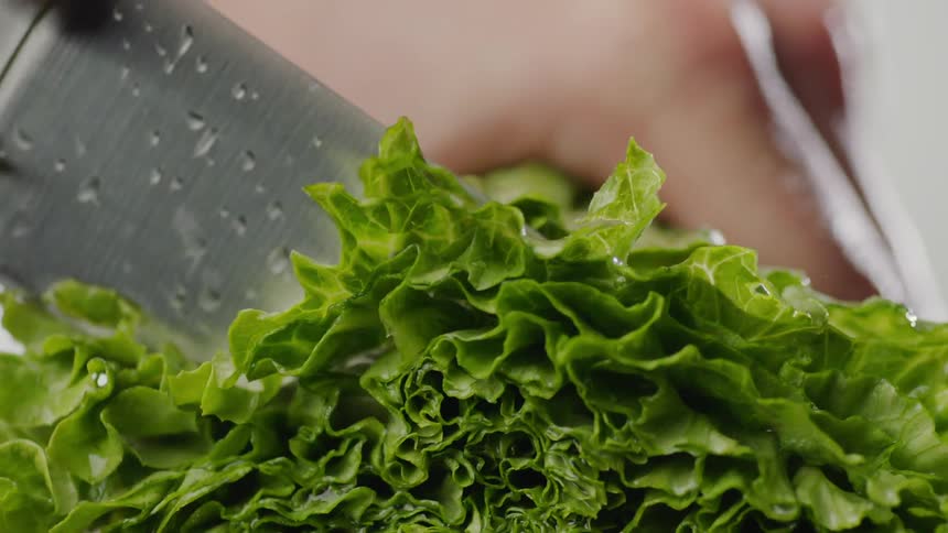 Lettuce is chopped with a knife