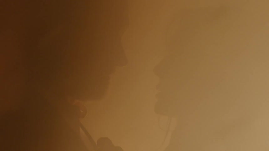 A fire burns around two lovers