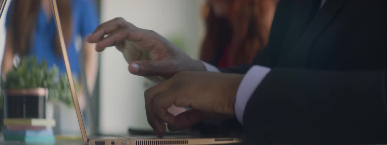 A man types on a computer than touches the screen