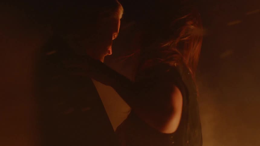 Couple Embracing While Surrounded By Fire