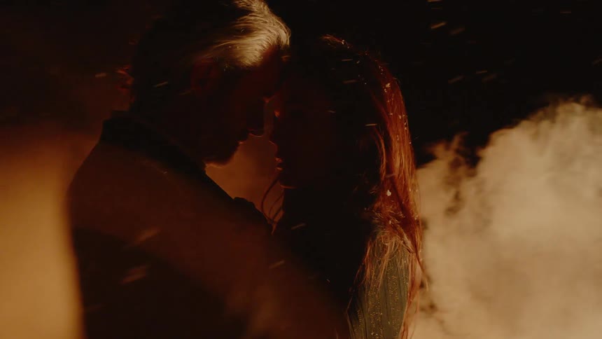 Couple Embracing While Surrounded By Fire