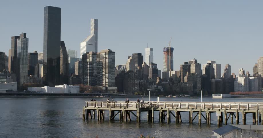 View of a city skyline and pier in a body of water