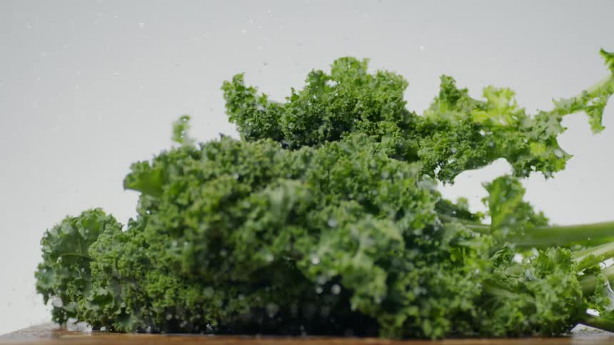 Kale falls onto a cutting board