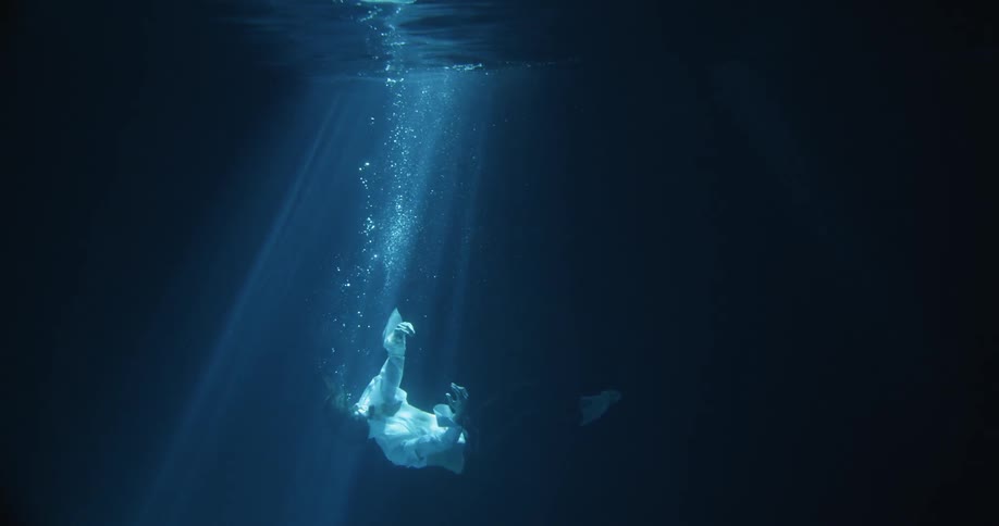 A man is floating down into the water