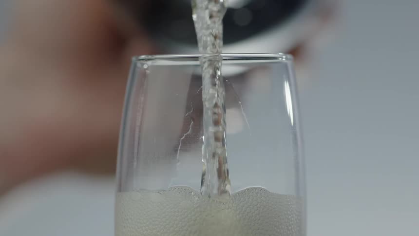 Person is pouring champagne into a glass