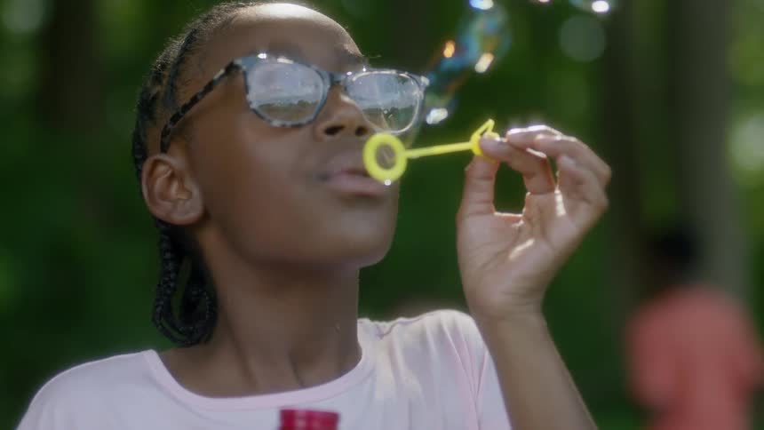 A girl blowing soap bubbles
