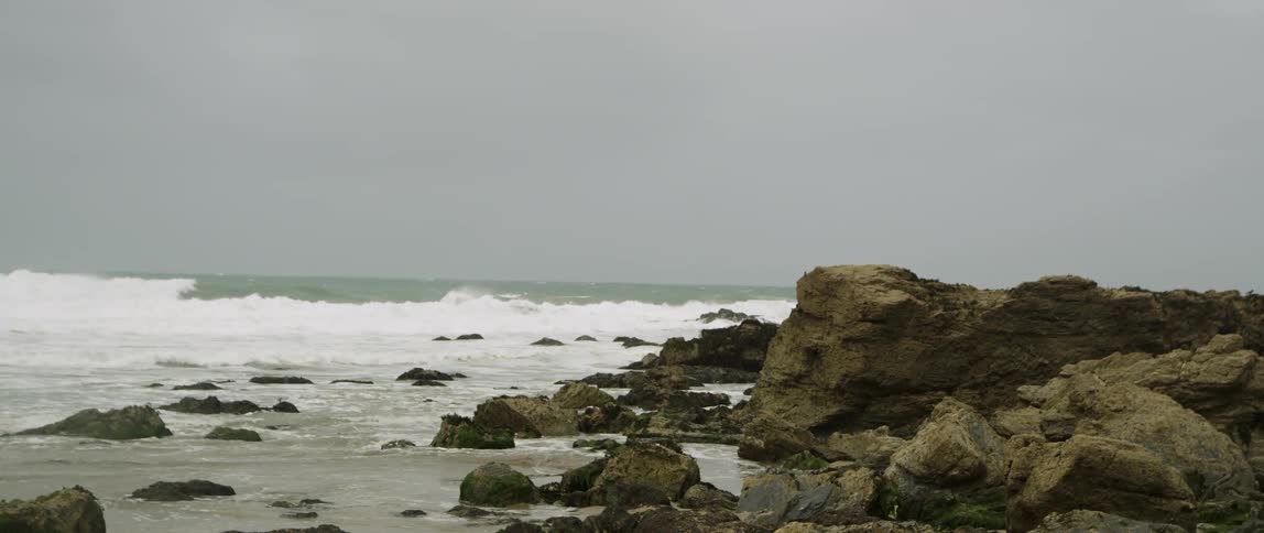 Waves are crashing by the rocks
