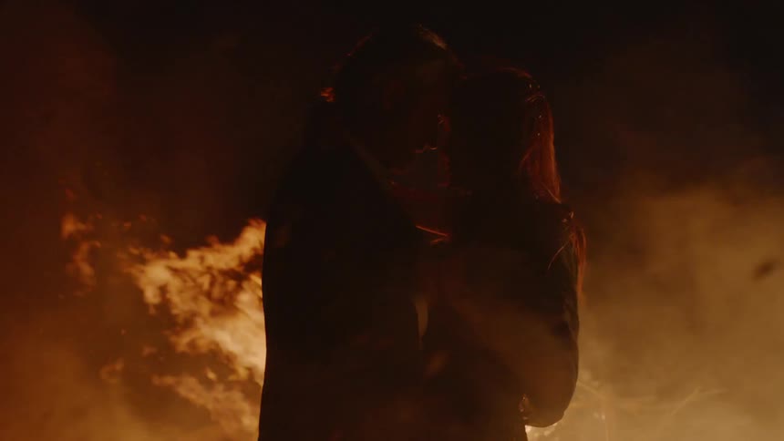 Couple Embracing While Surrounded By Fire