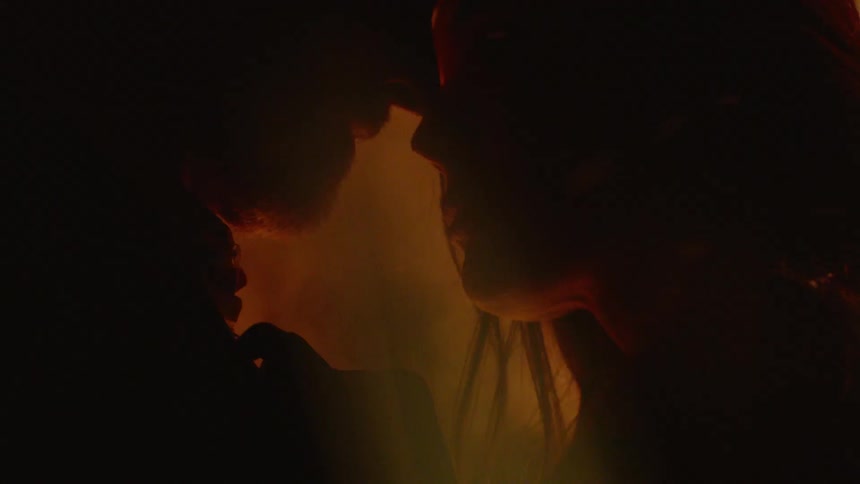 Man and woman are hugging by a fire