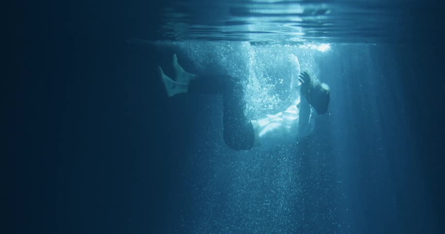 A man is floating beneath the water