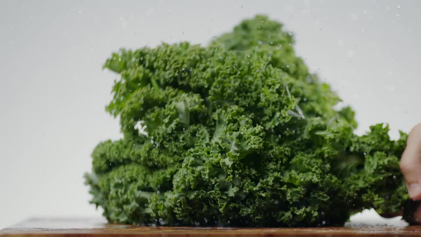 Vegetable is being thrown down on a table