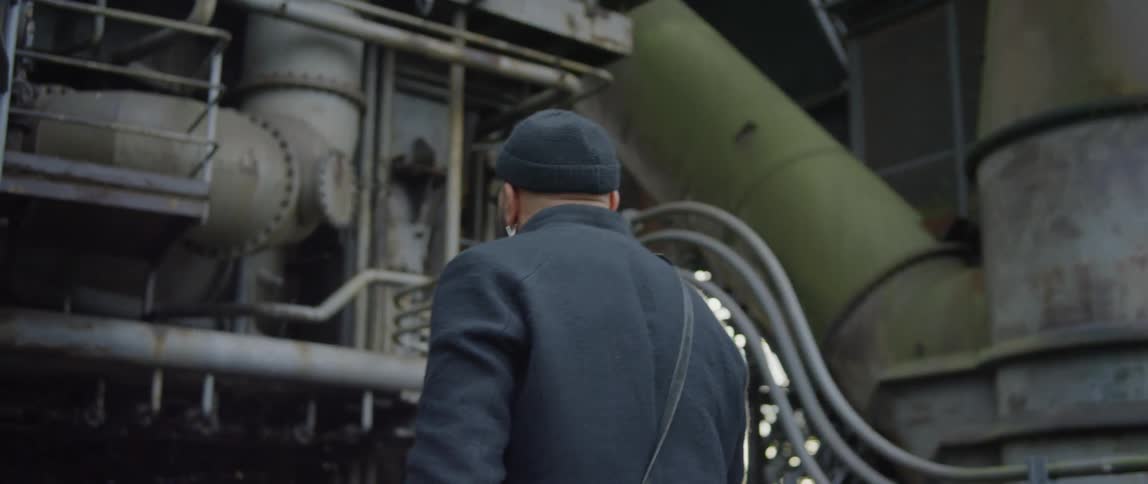 A man walking through an industrial site