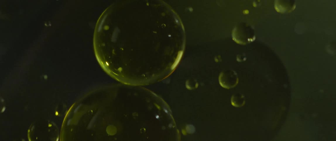 The small bubbles float around in the dark liquid