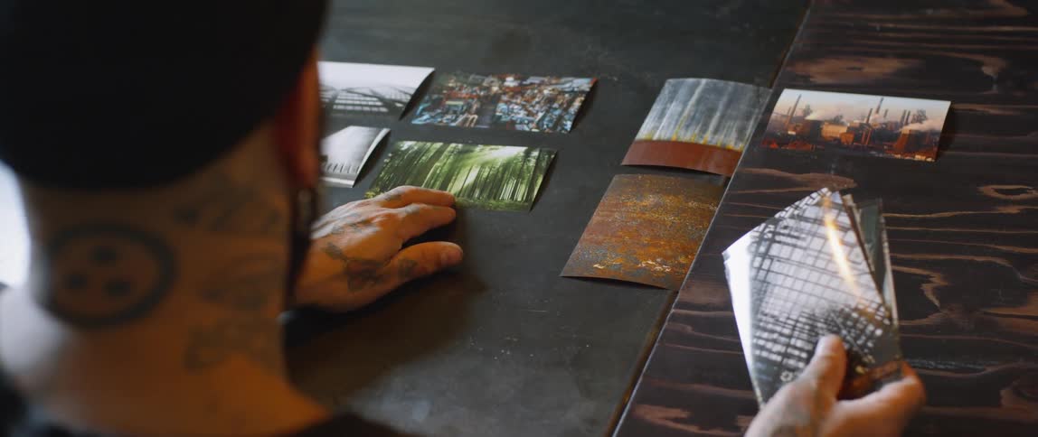 A man is putting photos on a table