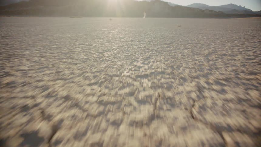 A person stands in the distance with the sun shining down