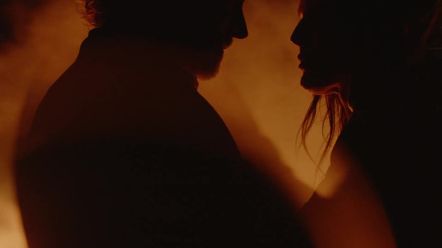 Couple Embracing While Surrounded By Fire