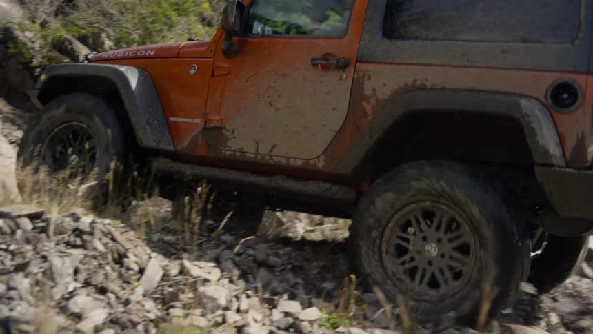 A jeep climbing a rocky mountain