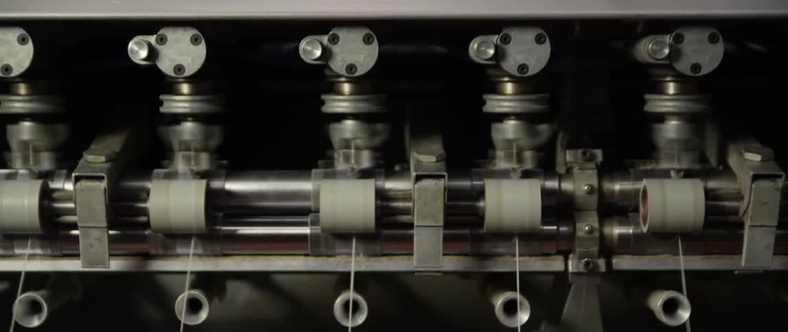 Thread is fed through an industrial machine