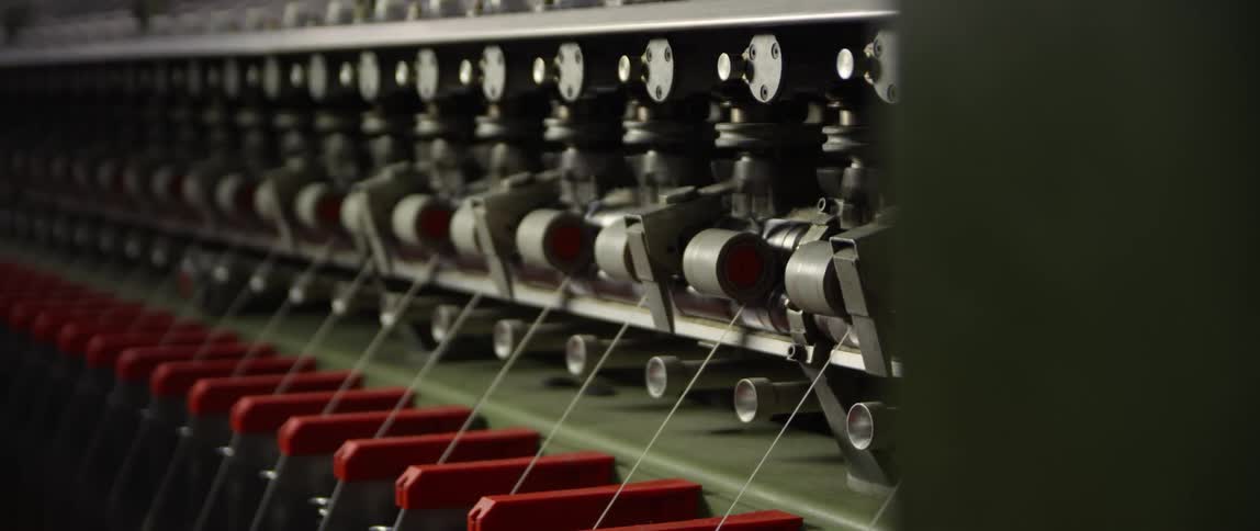 Thread is fed through an industrial machine