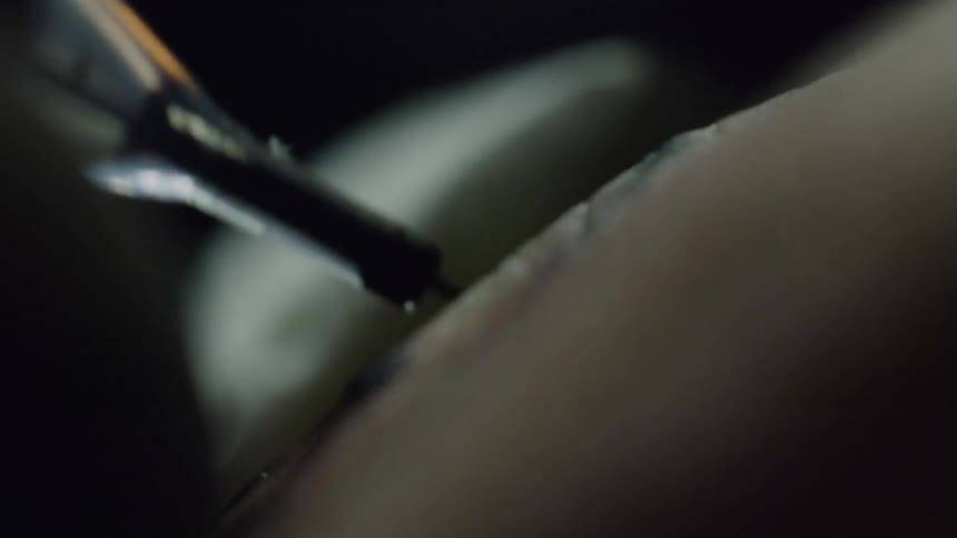 A hand being tattooed