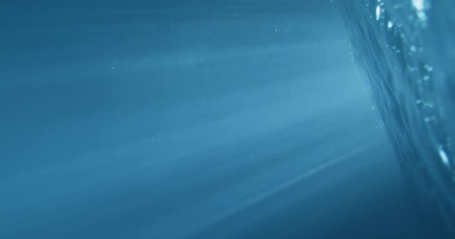 Lights shining through the surface of water
