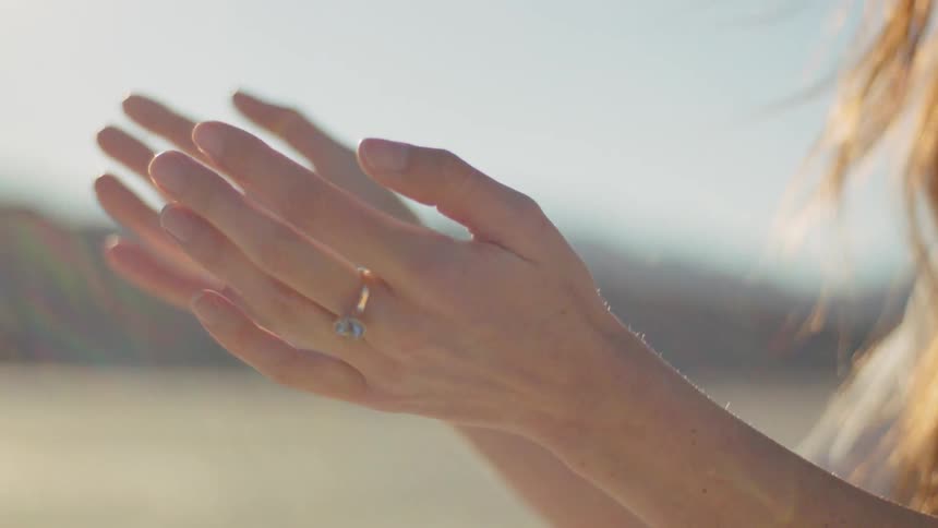 A woman moving her hands around in the desert